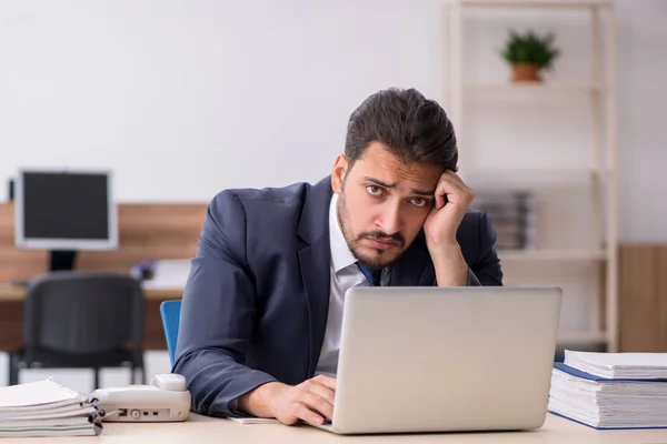 Jovem trabalhador masculino sentado no local de trabalho — Fotografia de Stock