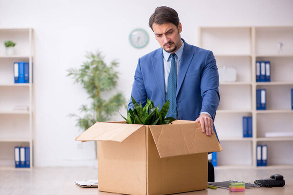 Young male employee in business relocation concept