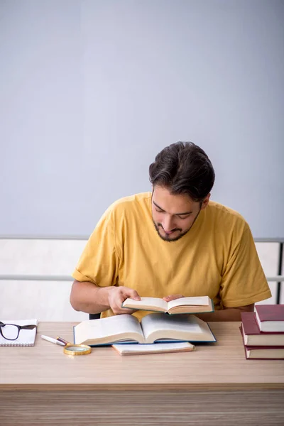 Joven estudiante masculino preparándose para los exámenes en el aula — Foto de Stock