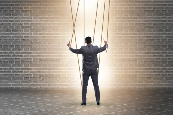 Businessman puppet being manipulated by ropes — Stock Photo, Image