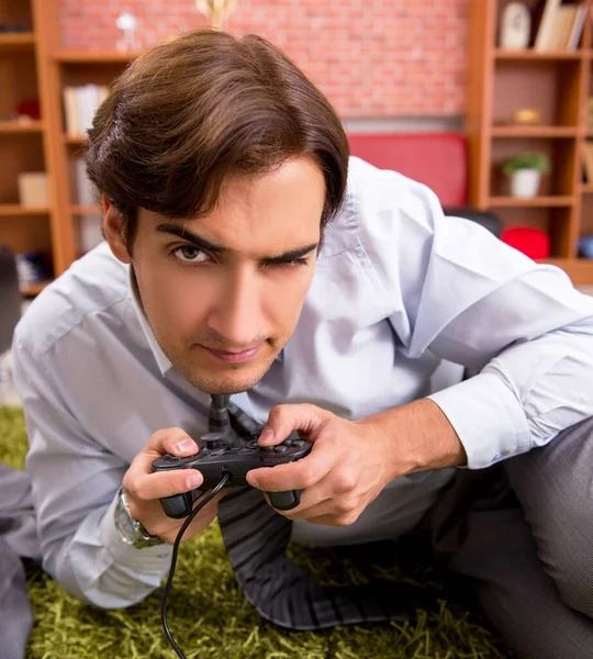 The young employee playing joystick games during his break — Stock Photo, Image