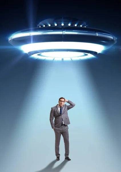 The flying saucer abducting young businessman — Stock Photo, Image