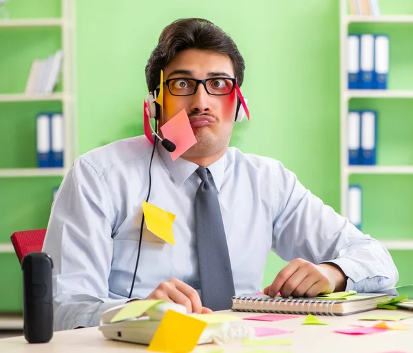 Young help desk operator working in office with many conflicting — Stock Photo, Image