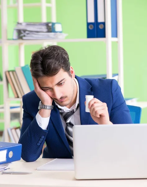 Podnikatel nešťastný z nadměrné práce sedí v kanceláři — Stock fotografie