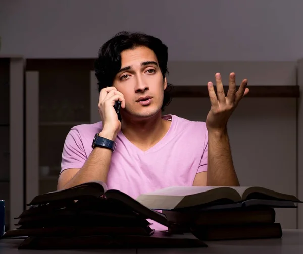 The male handsome student preparing for exams late at home — Stock Photo, Image