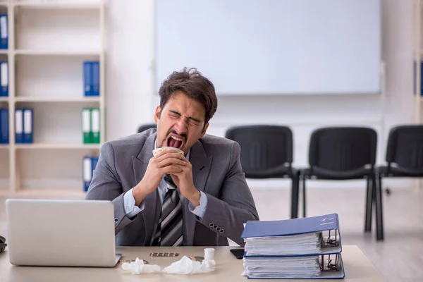 Young businessman employee suffering at workplace — Stock Photo, Image