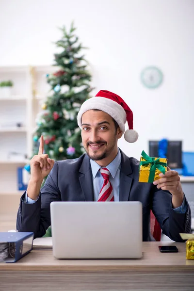 Giovane dipendente maschile che celebra il Natale sul posto di lavoro — Foto Stock