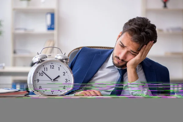 Young male employee in time management concept — Stock Photo, Image