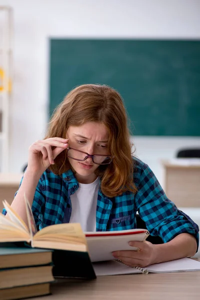 Young female student preparing for exam in the classroom — Stock Photo, Image