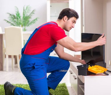 Profesyonel tamir mühendisi bozuk televizyonu tamir ediyor.