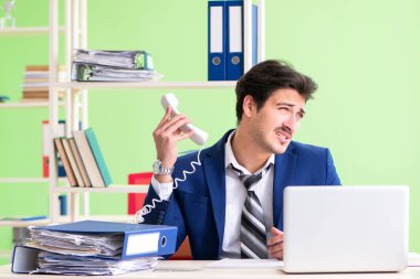 İşadamı ofiste aşırı çalışmaktan memnun değil.