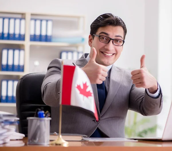 Businessman with Canadian flag in office — Stock Photo, Image