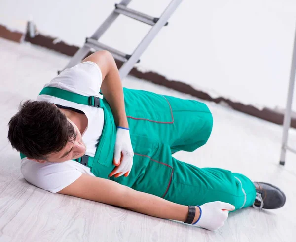 The young worker falling from the ladder — Stok fotoğraf