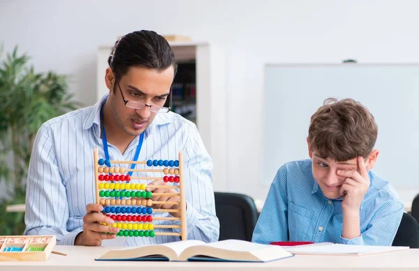 Padre joven ayudando a su hijo a prepararse para el examen —  Fotos de Stock