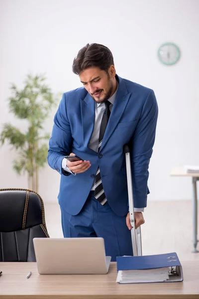 Young male employee after accident at workplace — Stock Photo, Image
