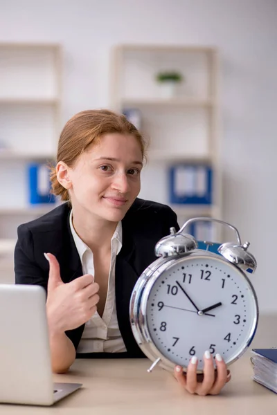 Young female employee in time management concept — Stock Photo, Image
