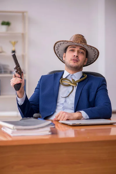 Young cowboy businessman working at workplace — Stock Photo, Image