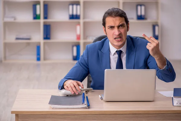 Young male employee sitting in the office — Stock Photo, Image