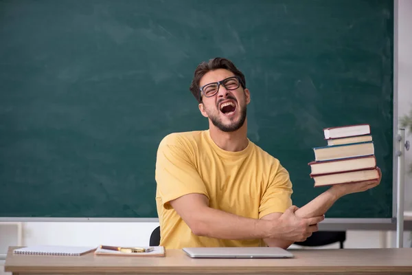 Joven estudiante masculino preparándose para los exámenes en el aula —  Fotos de Stock