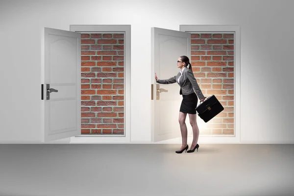 Businesswoman facing no exit with brick door — Stock Photo, Image