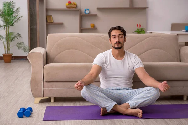 Jeune homme faisant des exercices sportifs à la maison — Photo