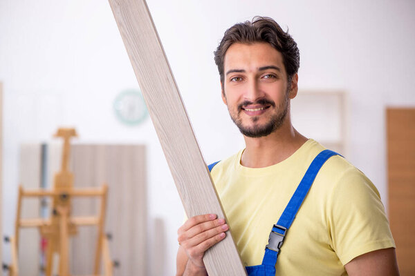 Young male carpenter working at workshop