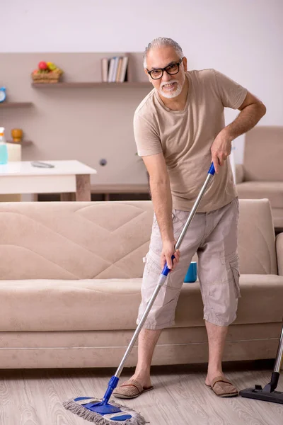 Yaşlı adam evde ev işi yapıyor. — Stok fotoğraf