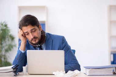 İş yerinde acı çeken genç bir erkek işçi.