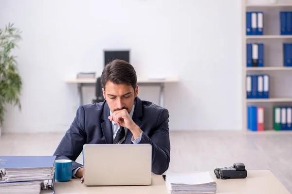 Young male employee sitting at workplace — Stock Photo, Image