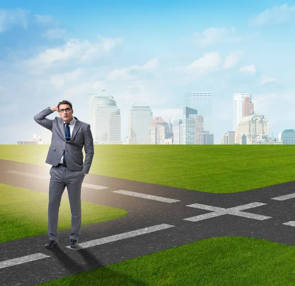 The young businessman at crossroads in uncertainty concept — Stock Photo, Image