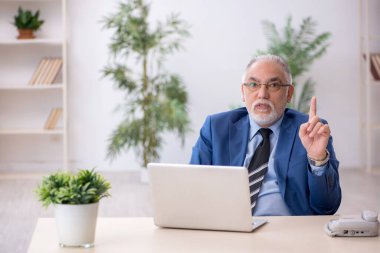 İş yerinde çalışan yaşlı bir işadamı