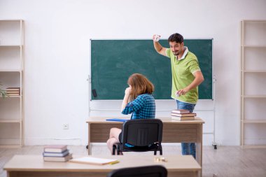 İki öğrenci sınıfta eğleniyor.