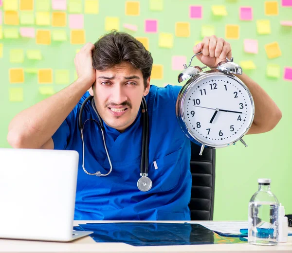 Ung läkare med många påminnelser och brådskande arbete — Stockfoto