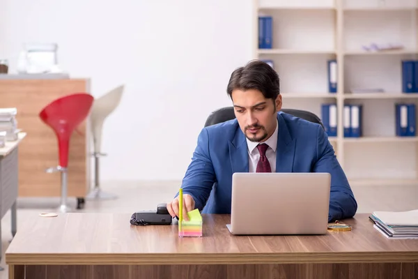 Young male employee sitting at workplace — Stock Photo, Image