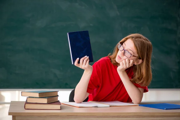 Jonge vrouwelijke student bereidt zich voor op examens in de klas — Stockfoto