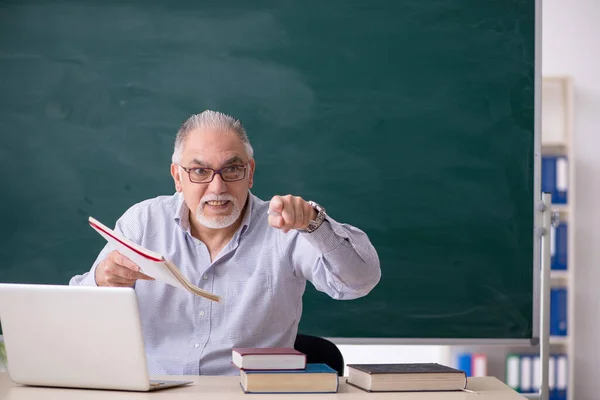 Oude mannelijke leraar voor het groene bord — Stockfoto