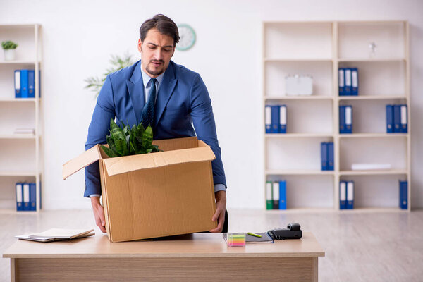 Young male employee in business relocation concept