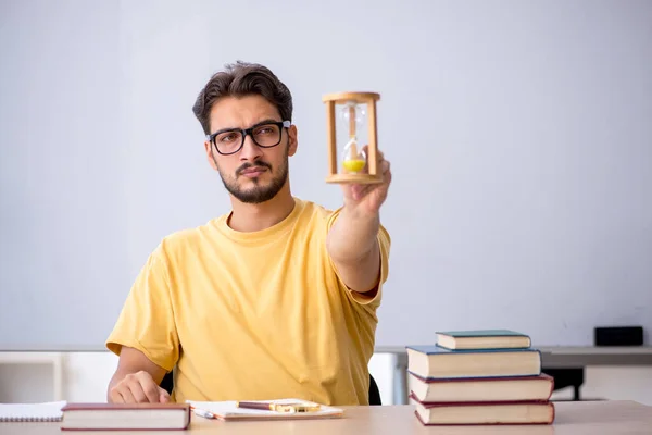 Young male student in time management concept — Stock Photo, Image