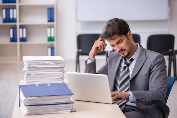 Young businessman employee and too much work in the office — Stock Photo, Image