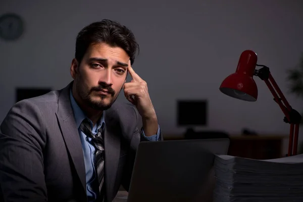 Young male employee working late in the office — Stock Photo, Image
