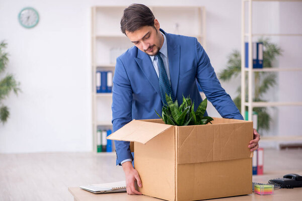 Young male employee in business relocation concept