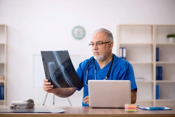 Starý lékař radiolog pracující na klinice — Stock fotografie