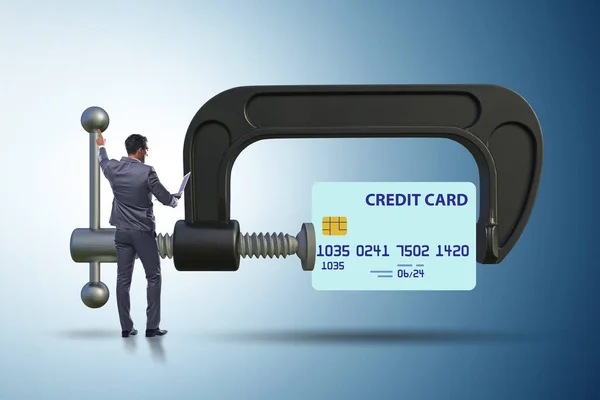 Concept of credit card debt with clamp and businessman — Foto Stock