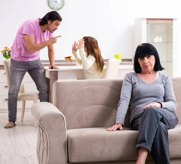 Young family and mother-in-law in family issues concept — Stock Photo, Image