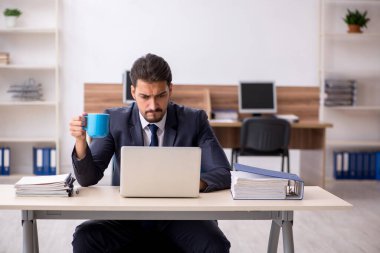 Molada kahve içen genç bir erkek.