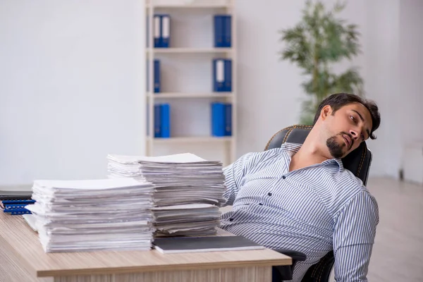 Joven empleado masculino descontento con el trabajo excesivo en la oficina —  Fotos de Stock