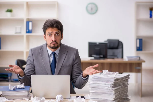 Junge männliche Mitarbeiter und zu viel Arbeit im Büro — Stockfoto