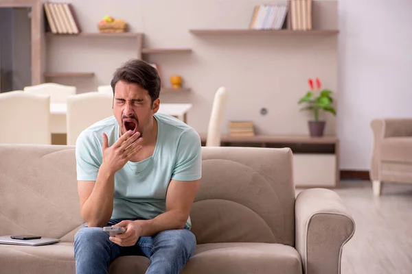 Young man student watching tv at home — Stock Photo, Image