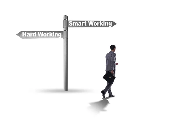 Businessman at the crossroads on working smart or hard — Stock Photo, Image