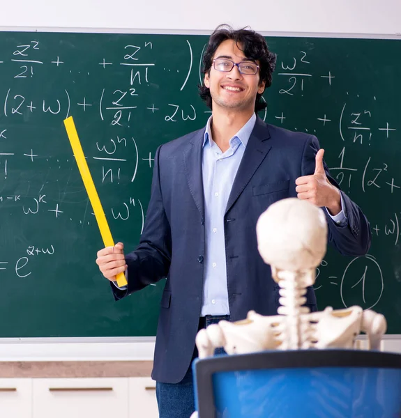 Young male math teacher and student skeleton